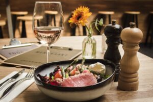 white wine with bowl of vegetable and fish