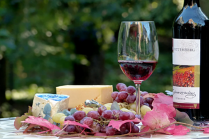 grapes, cheeses, and wine glass 
